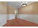 Dining room with a decorative chandelier, wood floors, and wainscoting details at 5418 Percival Ln, Charleston, SC 29420