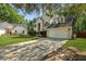 Picturesque two-story home with an attached garage, a well-maintained lawn, and mature trees at 5418 Percival Ln, Charleston, SC 29420