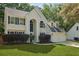Inviting two-story home with a lush front lawn, an attached garage, and elegant windows at 5418 Percival Ln, Charleston, SC 29420