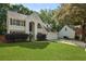 Traditional two-story home featuring a manicured lawn, attached garage, and charming architectural details at 5418 Percival Ln, Charleston, SC 29420