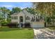 Charming two-story home with a well-manicured lawn, an attached garage, and traditional design at 5418 Percival Ln, Charleston, SC 29420