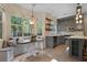 Sunlit kitchen with tile floors, painted cabinets, and breakfast nook with decorative lighting at 5418 Percival Ln, Charleston, SC 29420