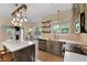 Eat-in kitchen features island, painted cabinets, stainless appliances, brick backsplash, and breakfast nook at 5418 Percival Ln, Charleston, SC 29420
