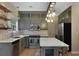 Charming kitchen with painted cabinets, brick backsplash, quartz countertops, and stainless steel appliances at 5418 Percival Ln, Charleston, SC 29420