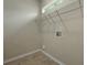 Clean laundry room featuring tile floors, a utility sink, and wire shelving above at 5418 Percival Ln, Charleston, SC 29420