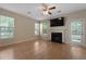 Bright living room with a fireplace, ceiling fan, and multiple windows at 5418 Percival Ln, Charleston, SC 29420