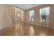 Sunlit living room with hardwood floors, neutral walls, and an open layout to the foyer at 5418 Percival Ln, Charleston, SC 29420