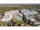Aerial view of a luxurious resort with pools, lush landscaping, and stunning coastal views at 5802 Palmetto Dr # B-501, Isle of Palms, SC 29451