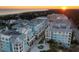 Scenic aerial view of a stunning resort with pools, lush landscaping, and oceanfront location at sunset at 5802 Palmetto Dr # B-501, Isle of Palms, SC 29451