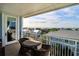Relaxing balcony with seating area overlooking ocean and coastal community views at 5802 Palmetto Dr # B-501, Isle of Palms, SC 29451