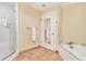 Elegant bathroom featuring tile flooring, a glass shower, and a garden tub at 5802 Palmetto Dr # B-501, Isle of Palms, SC 29451