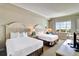 Inviting bedroom with two queen beds, ocean views, and comfortable seating area at 5802 Palmetto Dr # B-501, Isle of Palms, SC 29451