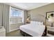 Bright bedroom featuring a large window, neutral decor, and comfortable bedding for a relaxing stay at 5802 Palmetto Dr # B-501, Isle of Palms, SC 29451