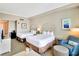 Comfortable hotel bedroom with two queen beds, a seating area, and neutral décor at 5802 Palmetto Dr # B-501, Isle of Palms, SC 29451
