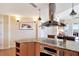 Well-appointed kitchen with stainless steel hood, granite countertops, and open layout to living spaces at 5802 Palmetto Dr # B-501, Isle of Palms, SC 29451