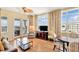 Bright living room with balcony access, floor-to-ceiling windows, and beautiful ocean views at 5802 Palmetto Dr # B-501, Isle of Palms, SC 29451