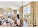 Open-concept living and dining area with a ceiling fan and access to the balcony with ocean views at 5802 Palmetto Dr # B-501, Isle of Palms, SC 29451
