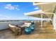 Expansive outdoor patio with comfortable seating and a stunning ocean view under a sunny sky at 5802 Palmetto Dr # B-501, Isle of Palms, SC 29451