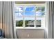 Window view featuring a glimpse of the ocean and nearby buildings against a blue sky at 5802 Palmetto Dr # B-501, Isle of Palms, SC 29451