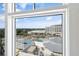 Scenic view from a window overlooking a pool and resort area with lush greenery at 5802 Palmetto Dr # B-501, Isle of Palms, SC 29451
