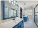 Primary bath boasts double sinks, a tile shower, and walk in closet access at 603 Curing Ct, Moncks Corner, SC 29461
