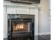 Elegant fireplace with a white mantle, black surround, and flickering flames at 603 Curing Ct, Moncks Corner, SC 29461