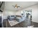 Bright living room featuring a fireplace, dark hardwood floors, and an extra large comfortable sectional at 603 Curing Ct, Moncks Corner, SC 29461