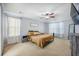 Serene bedroom features plush carpeting, a ceiling fan, a king bed, and streams of natural light at 603 Curing Ct, Moncks Corner, SC 29461