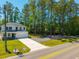 Beautiful two-story home featuring a long driveway and a well-maintained lawn on a sunny day at 689 W Butternut Rd, Summerville, SC 29483