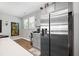 Modern kitchen featuring stainless fridge, gray cabinets, and a bright window for meal prep at 689 W Butternut Rd, Summerville, SC 29483