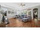Bright living room boasts hardwood floors, tray ceiling, fan, and comfortable seating with natural light at 689 W Butternut Rd, Summerville, SC 29483
