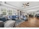 Spacious living room with hardwood floors, comfortable seating, and abundant natural light from windows at 689 W Butternut Rd, Summerville, SC 29483