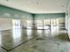 Spacious amenity room with polished concrete floor, light blue walls and a tennis net at 703 Hilchot Dr, Summerville, SC 29486