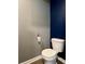 Standard toilet in bathroom with dual-tone wall and wood-look floor at 703 Hilchot Dr, Summerville, SC 29486