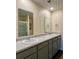 Vanity with dual sinks and mirrors complemented by a shower with glass enclosure in the bathroom at 703 Hilchot Dr, Summerville, SC 29486