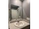 Well lit bathroom features a mirror above the sink with a gray wall that has electrical outlets and a towel rack at 703 Hilchot Dr, Summerville, SC 29486