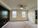 Bright bedroom with ceiling fan, soft carpet, black accent wall and large windows at 703 Hilchot Dr, Summerville, SC 29486