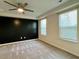 Spacious bedroom with ceiling fan and neutral carpet, black accent wall and bright window light at 703 Hilchot Dr, Summerville, SC 29486