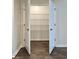 Walk-in closet offers ample storage with a configurable white wire shelving system and wood-look floors at 703 Hilchot Dr, Summerville, SC 29486