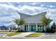 Modern clubhouse exterior with large windows and contemporary architecture, set amongst manicured landscaping at 703 Hilchot Dr, Summerville, SC 29486