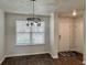 Elegant dining area with contemporary light fixture, natural light and hardwood floors at 703 Hilchot Dr, Summerville, SC 29486