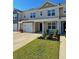 Well-manicured lawn highlights this townhome with an attached garage and a welcoming 'Welcome' sign at 703 Hilchot Dr, Summerville, SC 29486