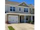 Charming townhome with attached garage and covered entryway, complemented by a well-maintained lawn at 703 Hilchot Dr, Summerville, SC 29486