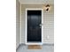 Close-up of a stylish black front door featuring a modern keypad and a welcoming doormat at 703 Hilchot Dr, Summerville, SC 29486