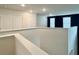 Upstairs hallway features views of a dark accent wall with windows that bring in natural light and carpeted floors at 703 Hilchot Dr, Summerville, SC 29486