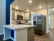 Kitchen features stainless steel appliances, wood floors, gray cabinets and white countertops at 703 Hilchot Dr, Summerville, SC 29486