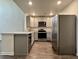 Bright kitchen features stainless steel appliances, wood floors, and gray cabinets at 703 Hilchot Dr, Summerville, SC 29486