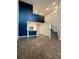 Open-concept living area with staircase and kitchen view under a tall, dark accent wall at 703 Hilchot Dr, Summerville, SC 29486