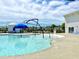 Community swimming pool area featuring a fun splash fountain, seating areas, and nearby clubhouse at 703 Hilchot Dr, Summerville, SC 29486