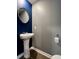 Powder room features pedestal sink, modern mirror, toilet, and painted accent wall at 703 Hilchot Dr, Summerville, SC 29486
